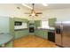 Efficient kitchen with green cabinets and stainless steel appliances at 2804 Holloway Rd, Plant City, FL 33567