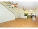 Open floor plan with kitchen and living area, hardwood floors, and ceiling fans at 2804 Holloway Rd, Plant City, FL 33567