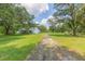 White barn and expansive yard with trees at 2804 Holloway Rd, Plant City, FL 33567