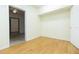 Small bedroom with wood-look floors and access to another room at 2804 Holloway Rd, Plant City, FL 33567