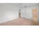 Well-lit bedroom with carpet and access to the bathroom at 2465 Northside Dr # 701, Clearwater, FL 33761