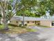 Tan single story home with green shutters and a spacious yard at 2465 Northside Dr # 701, Clearwater, FL 33761