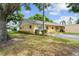 Tan single story home with green shutters and a grassy area at 2465 Northside Dr # 701, Clearwater, FL 33761