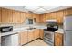 Kitchen with wood cabinets, stainless steel appliances at 2465 Northside Dr # 701, Clearwater, FL 33761