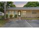 Evening view of tan house with green door and landscaping at 2465 Northside Dr # 701, Clearwater, FL 33761