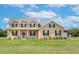Two-story house with a red door and barn at 8703 Alafia Hills Dr, Plant City, FL 33567