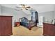 Bedroom with dark wood furniture and neutral decor at 8703 Alafia Hills Dr, Plant City, FL 33567