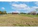 Property features a home, barn, and expansive grassy area at 8703 Alafia Hills Dr, Plant City, FL 33567