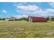 Red barn next to house with large yard at 8703 Alafia Hills Dr, Plant City, FL 33567