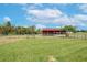 Red barn with stalls and fenced-in area at 8703 Alafia Hills Dr, Plant City, FL 33567