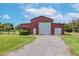 Large red barn with double garage doors at 8703 Alafia Hills Dr, Plant City, FL 33567