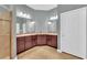 Double vanity bathroom with dark wood cabinets at 8703 Alafia Hills Dr, Plant City, FL 33567