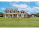 Two-story house with a red door and barn at 8703 Alafia Hills Dr, Plant City, FL 33567