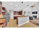 Open kitchen with granite island and gas range at 8703 Alafia Hills Dr, Plant City, FL 33567