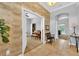 Bright entryway with wood-paneled accent wall and view to living room at 8703 Alafia Hills Dr, Plant City, FL 33567
