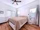 Comfortable bedroom with king bed, double doors, and hardwood floors at 6564 Simone Shores Cir, Apollo Beach, FL 33572