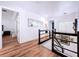 Light and airy upstairs hallway, featuring stylish decor and wood floors at 6564 Simone Shores Cir, Apollo Beach, FL 33572