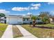 Ranch style home with a two car driveway and mature landscaping at 3615 Latimer St, New Port Richey, FL 34652