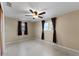 Bright bedroom with ceiling fan, window, and mirrored closet at 3615 Latimer St, New Port Richey, FL 34652