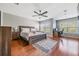 Spacious main bedroom with wood floors, ceiling fan, and private office area at 20270 Merry Oak Ave, Tampa, FL 33647