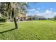 Large backyard with grassy area and patio at 20270 Merry Oak Ave, Tampa, FL 33647