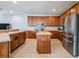Bright kitchen featuring an island, stainless steel appliances, and wood cabinets at 20270 Merry Oak Ave, Tampa, FL 33647