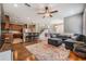 Open living room with hardwood floors, sectional sofa, and ceiling fan at 20270 Merry Oak Ave, Tampa, FL 33647