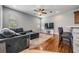 Bright living room featuring hardwood floors, sectional sofa, and large windows at 20270 Merry Oak Ave, Tampa, FL 33647