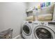 Laundry room with washer, dryer, and ample shelving at 20270 Merry Oak Ave, Tampa, FL 33647