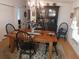 Bright dining room featuring a rustic wooden table with black chairs and a large hutch at 197 Philadelphia Blvd # 26, Palm Harbor, FL 34684