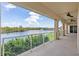 Balcony overlooking a lake and fountain, with view of manicured landscaping and a ceiling fan at 43 Bayview S Ct # A, St Petersburg, FL 33711