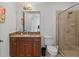 Bathroom features a vanity with granite countertop, framed mirror, and glass-enclosed shower at 43 Bayview S Ct # A, St Petersburg, FL 33711
