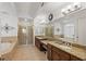Primary bathroom featuring double sinks, soaking tub, and walk-in shower at 43 Bayview S Ct # A, St Petersburg, FL 33711