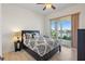 Bedroom with dark furniture, balcony access, and waterfront views at 43 Bayview S Ct # A, St Petersburg, FL 33711