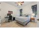 Bright bedroom with ceiling fan, a desk with computer, and bedside table with curtains framing the windows at 43 Bayview S Ct # A, St Petersburg, FL 33711