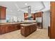 Large kitchen features stainless steel appliances, granite counters, wood cabinetry and a central island with cooktop at 43 Bayview S Ct # A, St Petersburg, FL 33711