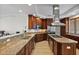 Gourmet kitchen with stainless steel appliances, granite countertops, a central island, and wooden cabinets at 43 Bayview S Ct # A, St Petersburg, FL 33711