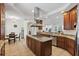 Spacious kitchen features stainless appliances, granite counters, wood cabinets, and an island with a cooktop at 43 Bayview S Ct # A, St Petersburg, FL 33711