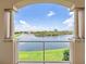 Picturesque view of a lake from a covered balcony with fountain at 43 Bayview S Ct # A, St Petersburg, FL 33711