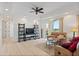 Inviting living room with light hardwood floors, ceiling fan, and sliding glass doors with views of the lake at 43 Bayview S Ct # A, St Petersburg, FL 33711