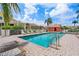 Relaxing community pool area with lounge chairs, mature landscaping, and sunny blue skies at 43 Bayview S Ct # A, St Petersburg, FL 33711