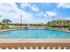 Relaxing community pool area with seating, mature landscaping, and sunny skies at 43 Bayview S Ct # A, St Petersburg, FL 33711