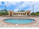 Beautiful community pool and clubhouse with manicured landscaping, seating, and sunny skies at 43 Bayview S Ct # A, St Petersburg, FL 33711