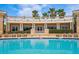 Gorgeous community pool and clubhouse with manicured landscaping, seating, and palm trees at 43 Bayview S Ct # A, St Petersburg, FL 33711