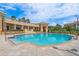 Beautiful community pool and clubhouse with manicured landscaping, seating, and palm trees at 43 Bayview S Ct # A, St Petersburg, FL 33711
