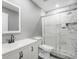 Modern bathroom with white vanity, marble shower, and gray walls at 9716 Fox Chapel Rd, Tampa, FL 33647