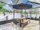 Covered patio with table, chairs, and umbrella at 32216 Cottage Glen Ln, Wesley Chapel, FL 33545