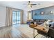 Relaxing living room featuring hardwood floors and a sectional sofa at 32216 Cottage Glen Ln, Wesley Chapel, FL 33545