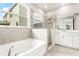 Main bathroom with soaking tub, walk-in shower, and double vanity at 23176 Pachino Way, Lutz, FL 33549