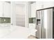 Walk-in pantry and stainless steel refrigerator in kitchen at 23176 Pachino Way, Lutz, FL 33549